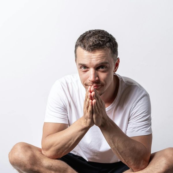 Person meditating peacefully with a calm expression.